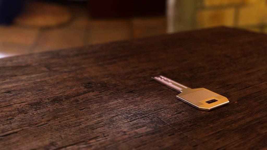 small metal key on table
